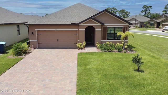 view of front of property with an attached garage, roof with shingles, decorative driveway, stucco siding, and a front lawn