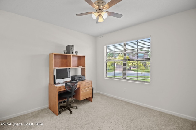 office featuring ceiling fan and light carpet