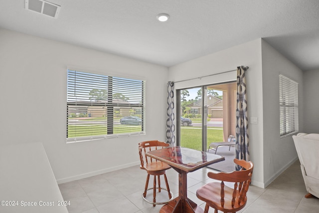 dining area featuring light tile patterned flooring