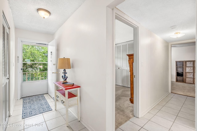 tiled foyer with a textured ceiling