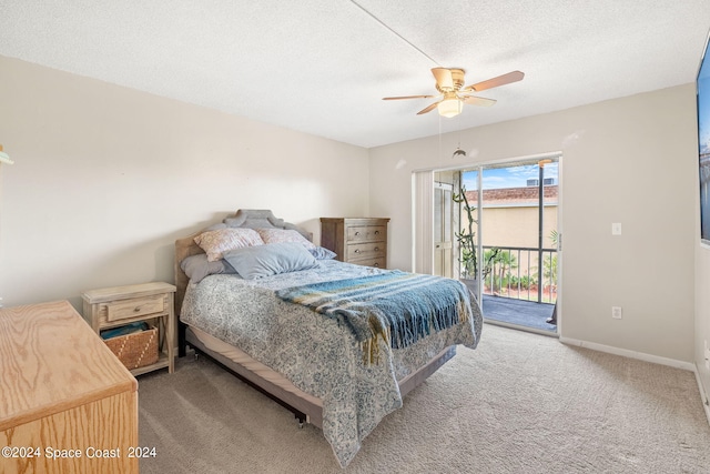 bedroom with ceiling fan, access to outside, a textured ceiling, and carpet flooring