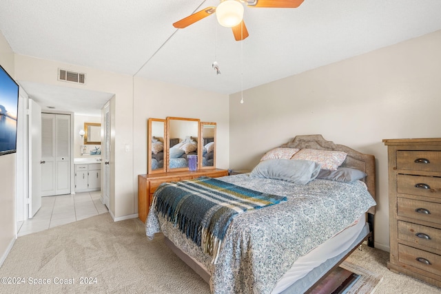 carpeted bedroom featuring ceiling fan and ensuite bath