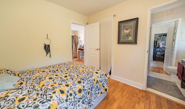 bedroom featuring hardwood / wood-style floors and connected bathroom