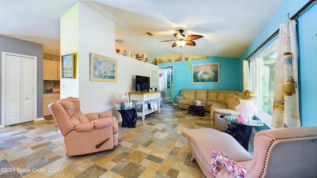 living room with a textured ceiling, lofted ceiling, and ceiling fan