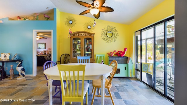 dining space with vaulted ceiling and ceiling fan