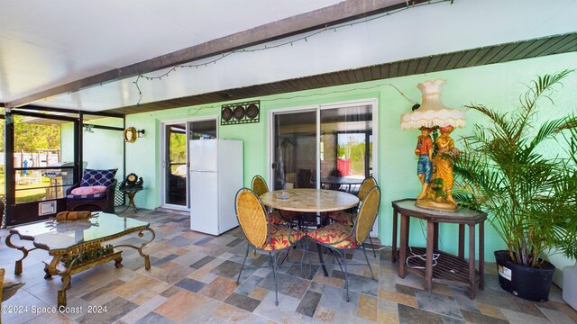 sunroom featuring beamed ceiling