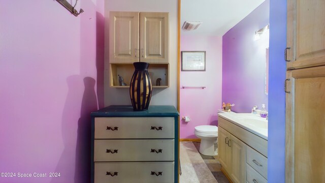 bathroom featuring vanity and toilet