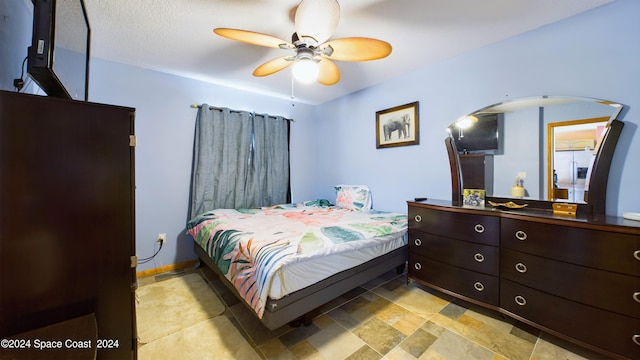 bedroom with a textured ceiling and ceiling fan