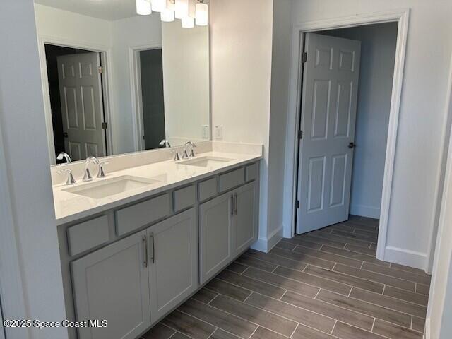 3742 Ornis Ct, Grant-Valkaria, FL 32950 - full bathroom with double vanity, wood finish floors, and baseboards