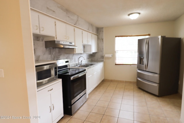 kitchen featuring white cabinetry, appliances with stainless steel finishes, sink, and extractor fan