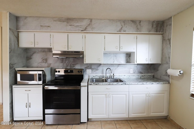 kitchen featuring sink, backsplash, white cabinetry, and stainless steel appliances