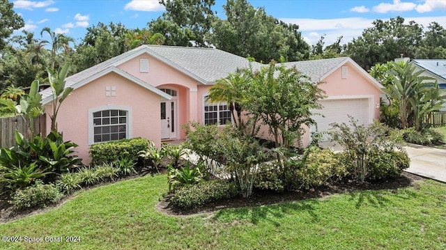 ranch-style home with a front yard and a garage