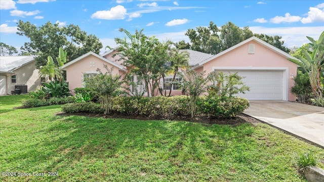 ranch-style house featuring cooling unit, a front lawn, and a garage