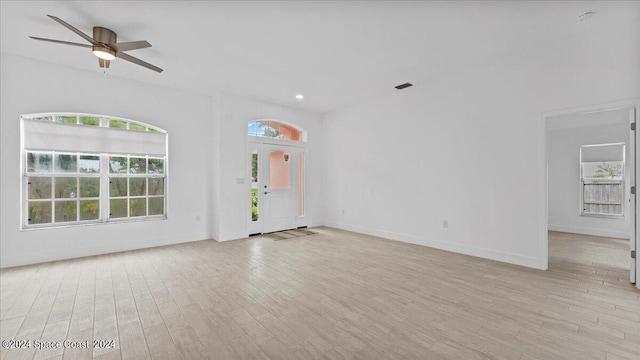 empty room with light wood-type flooring and ceiling fan