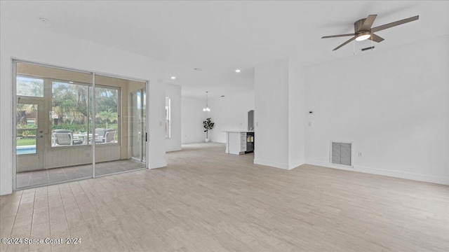 unfurnished living room featuring ceiling fan and light hardwood / wood-style floors