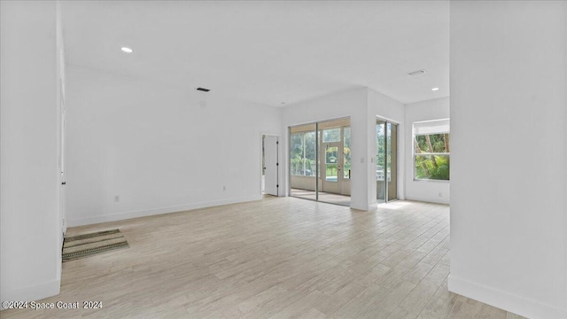 unfurnished room with light wood-type flooring