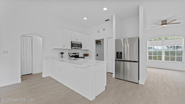 kitchen featuring light hardwood / wood-style flooring, stainless steel appliances, kitchen peninsula, white cabinetry, and ceiling fan