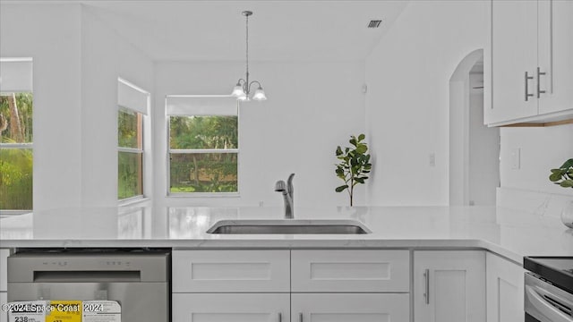 kitchen with plenty of natural light, sink, decorative light fixtures, and white cabinets