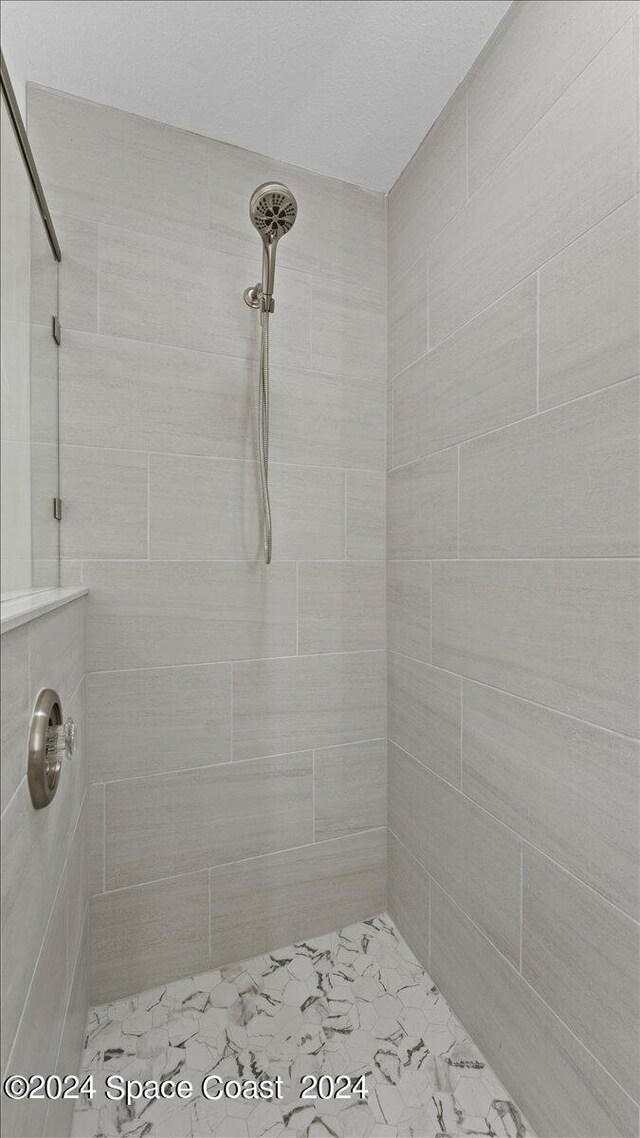 bathroom with tiled shower