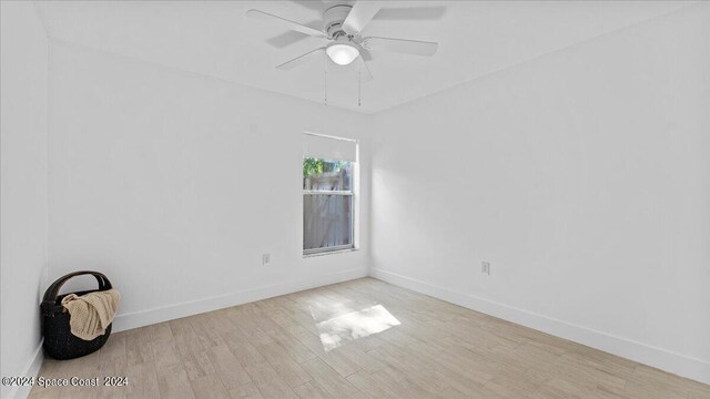 spare room featuring light wood-type flooring and ceiling fan