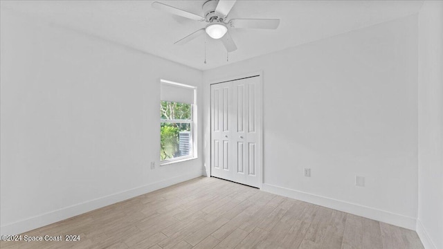 spare room featuring ceiling fan and light hardwood / wood-style flooring