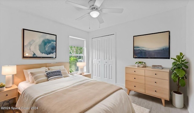 bedroom featuring ceiling fan, a closet, and light hardwood / wood-style floors