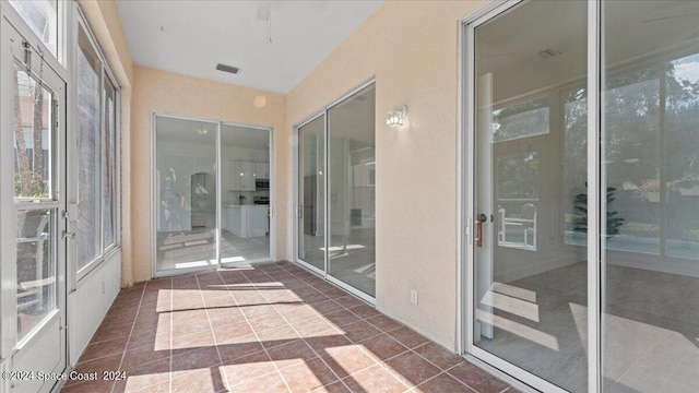 unfurnished sunroom featuring plenty of natural light