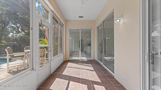 unfurnished sunroom with plenty of natural light