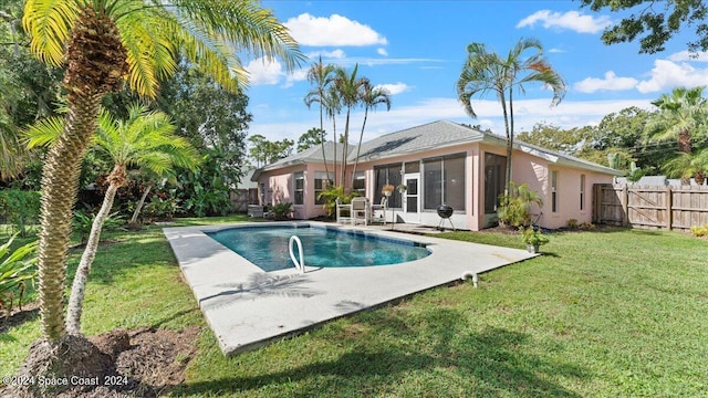 view of pool featuring a lawn and a patio