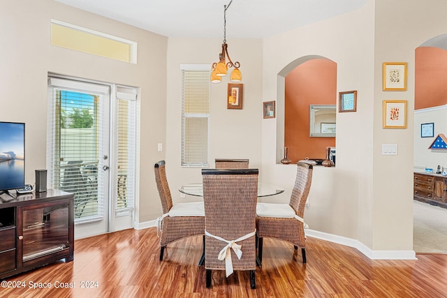 dining room featuring an inviting chandelier and light hardwood / wood-style floors