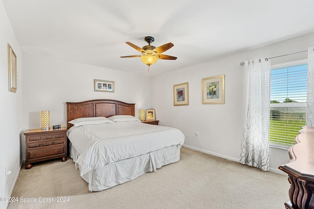 bedroom with ceiling fan and light colored carpet