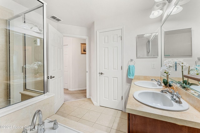 bathroom with tile patterned flooring, vanity, and an enclosed shower