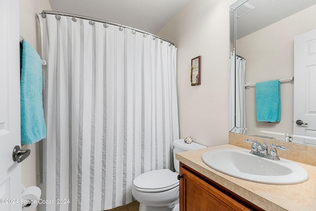 bathroom featuring vanity, toilet, and walk in shower