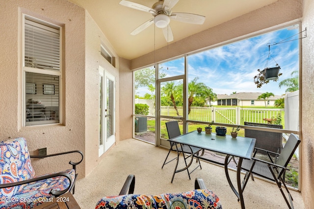 sunroom featuring ceiling fan