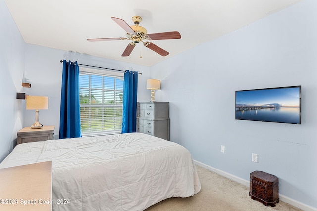 bedroom featuring light colored carpet and ceiling fan