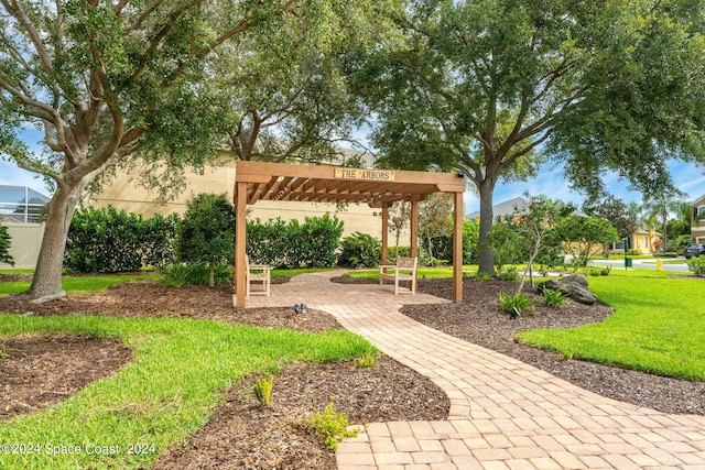 view of home's community featuring a pergola and a lawn