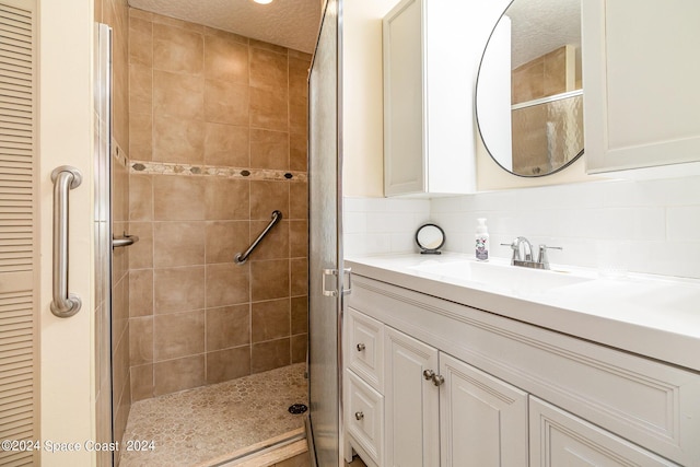 full bathroom with a textured ceiling, a closet, a stall shower, and decorative backsplash