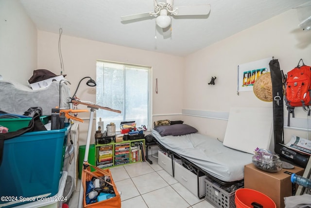 tiled bedroom featuring ceiling fan