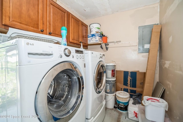 laundry room featuring cabinets, electric panel, and washer and dryer