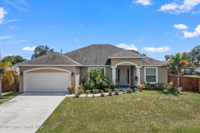 ranch-style house with a garage and a front lawn