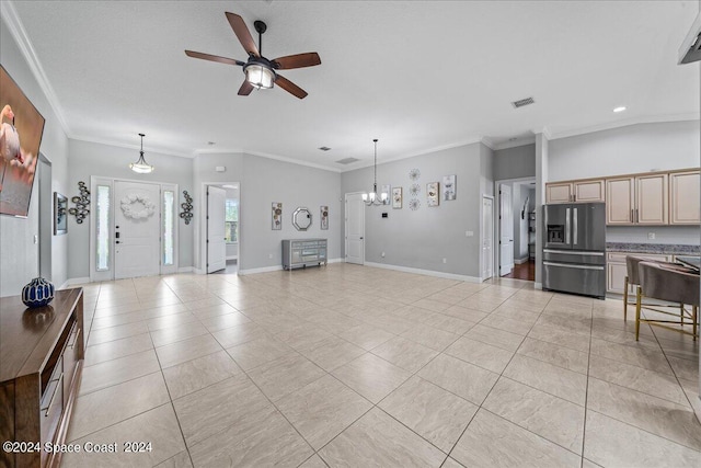 living room with ceiling fan with notable chandelier, light tile patterned floors, and ornamental molding