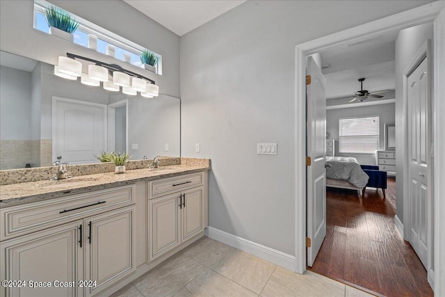 bathroom featuring ceiling fan, double vanity, and tile patterned floors