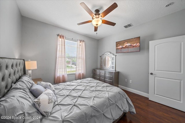 bedroom featuring ceiling fan, hardwood / wood-style flooring, and a textured ceiling