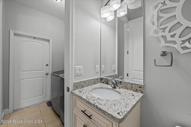 bathroom featuring a textured ceiling, vanity, and tile patterned floors