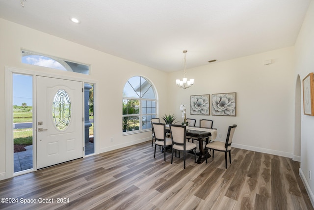 foyer entrance featuring an inviting chandelier and hardwood / wood-style flooring