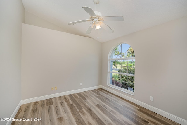 unfurnished room featuring ceiling fan, vaulted ceiling, and wood-type flooring