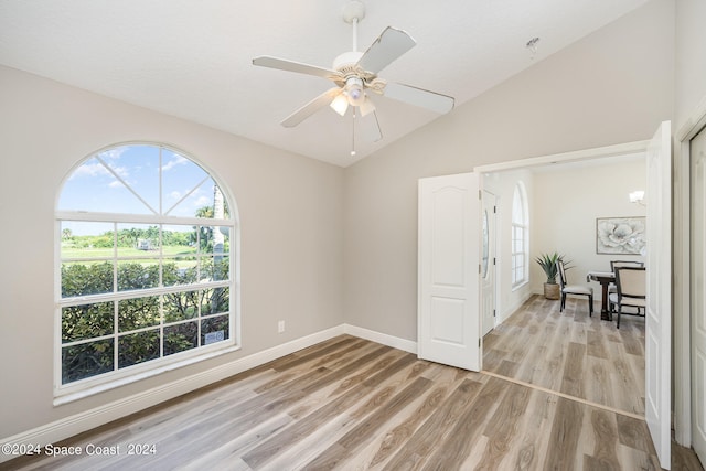 unfurnished room featuring ceiling fan, vaulted ceiling, and light hardwood / wood-style floors