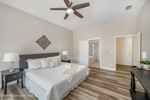 bedroom with ceiling fan, hardwood / wood-style floors, and connected bathroom