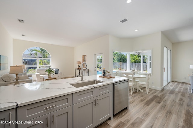 kitchen with a wealth of natural light, dishwasher, gray cabinets, and sink