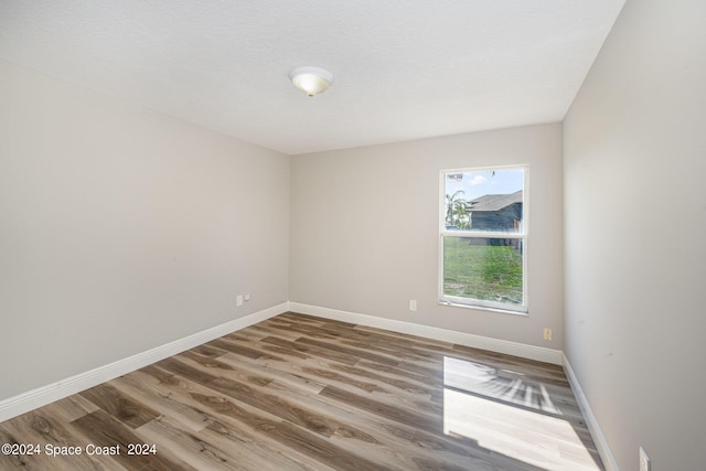 empty room with hardwood / wood-style floors